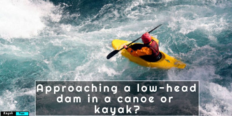 what should you do when approaching a low-head dam in a canoe or kayak?